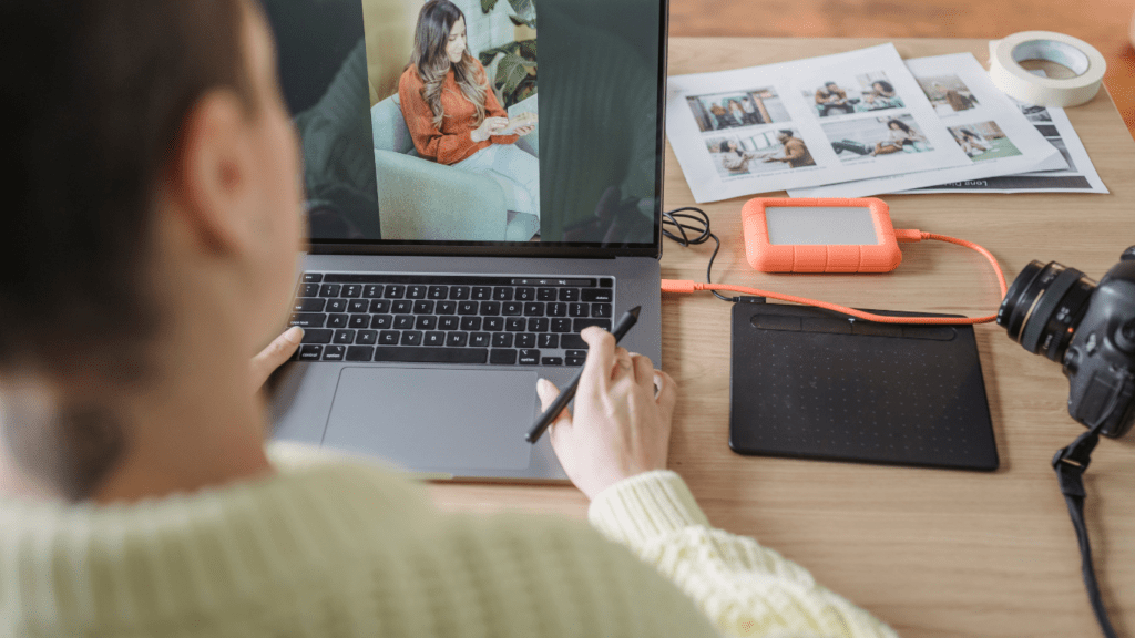 A person sitting at a desk with a laptop and camera