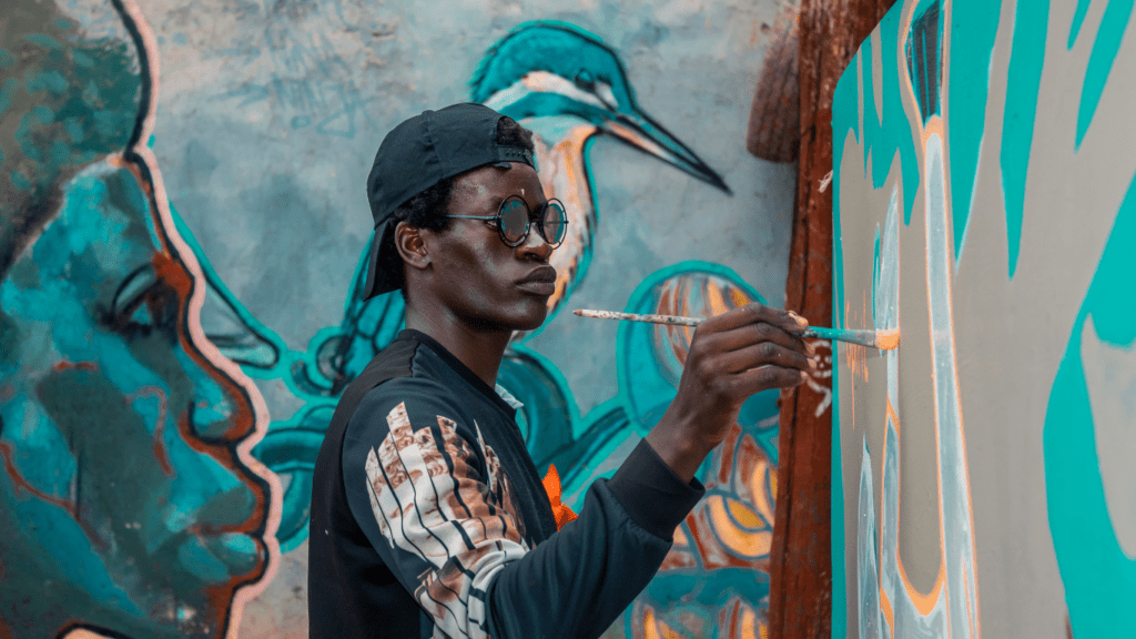 artist making a mural paint