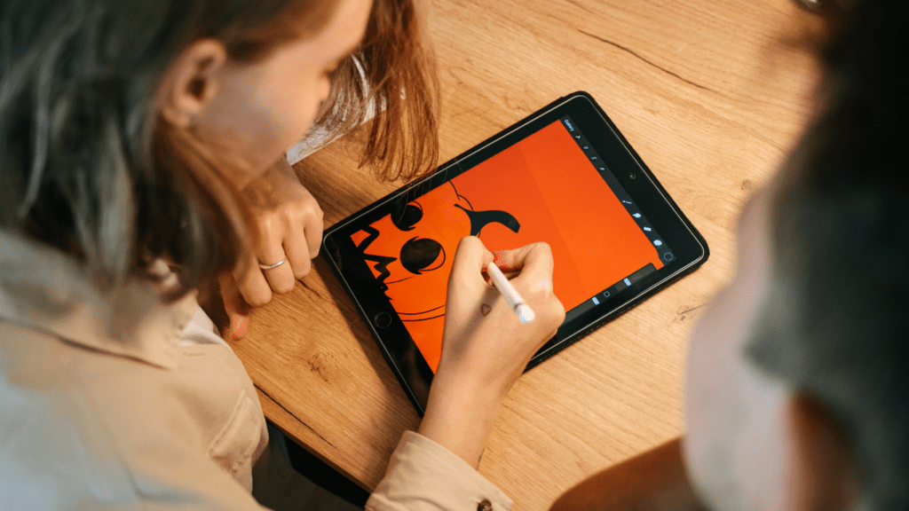 someone is drawing on a tablet computer