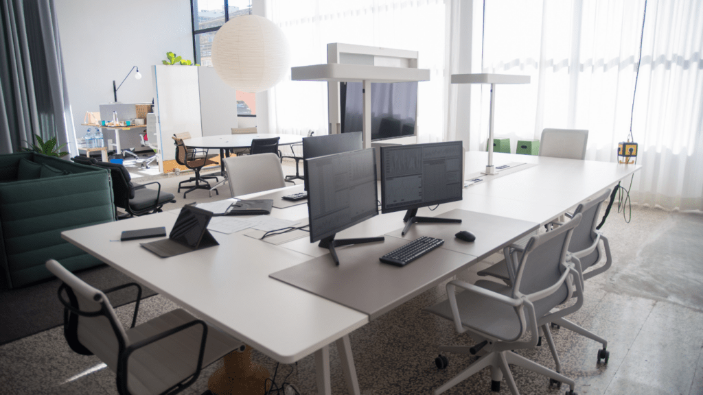 an open office space with multiple computers and chairs