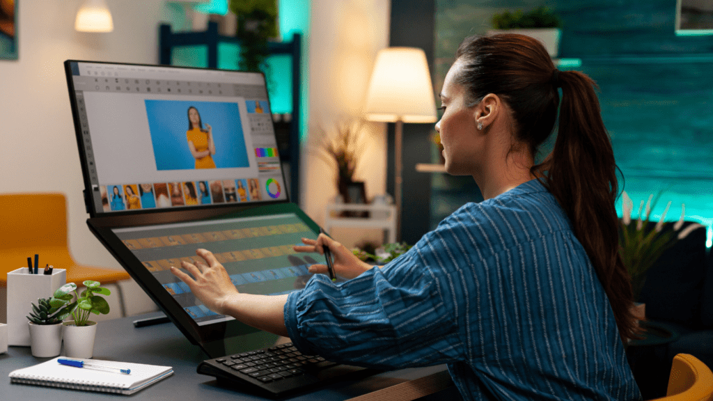 a person is working on a computer in front of a computer monitor